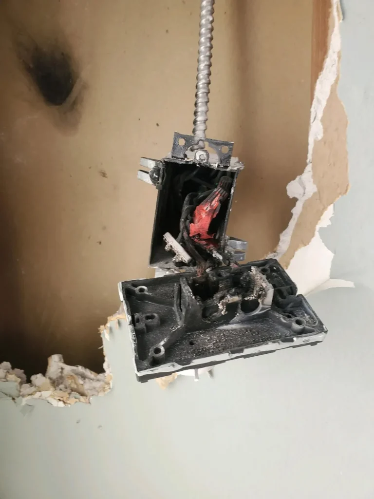 Why Did My Electrical Outlet Stop Working? 3 Fire-damaged electrical outlet showing burn damage in a wall